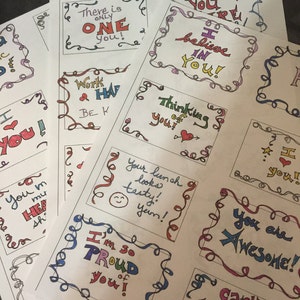 May include: A collection of colorful, handwritten motivational cards with messages like "You are Awesome!" and "I believe in you!" The cards are printed on white paper with a decorative border.