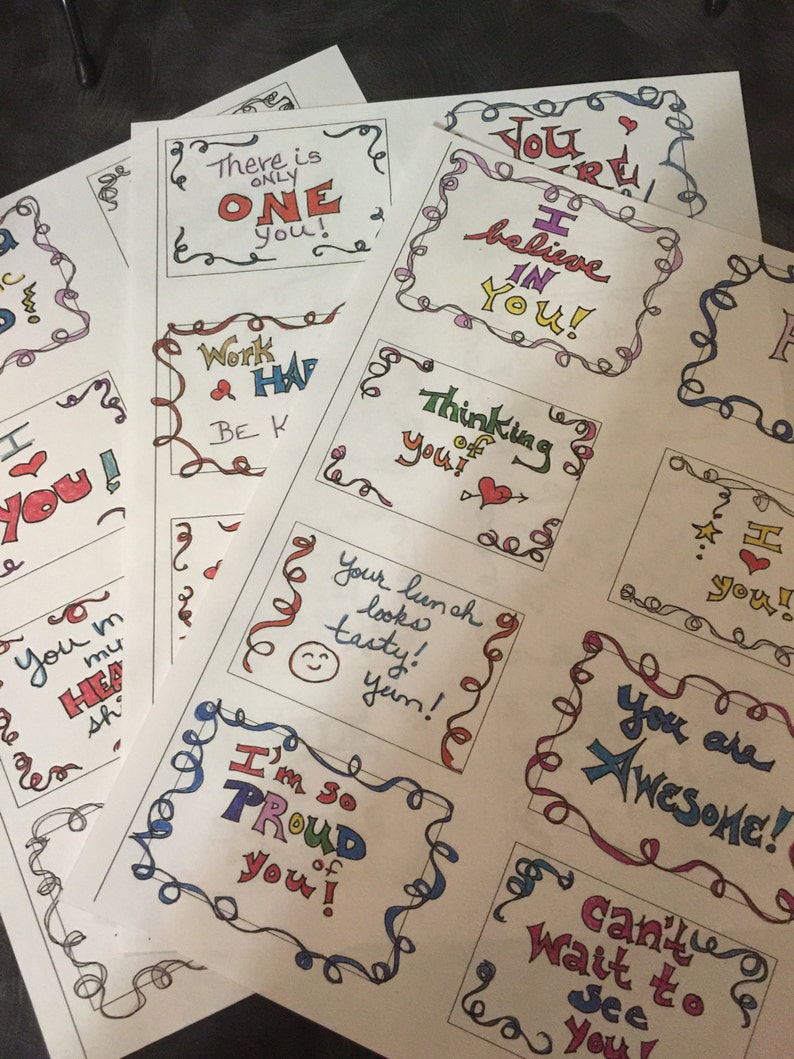 May include: A collection of colorful, handwritten motivational cards with messages like "You are Awesome!" and "I believe in you!" The cards are printed on white paper with a decorative border.