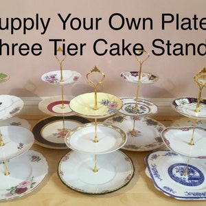 May include: Three-tier cake stands with gold metal supports and various patterned porcelain plates. The text "Supply Your Own Plates Three Tier Cake Stands" is at the top of the image.