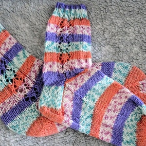stripey patterned hand made socks for little feet one pastel one bold