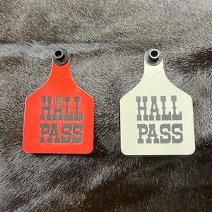 May include: Two plastic red and white tags with the text "Hall Pass" in black lettering.