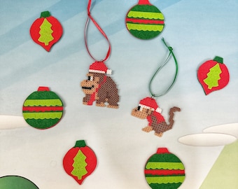 May include: A set of ten Christmas ornaments featuring a green and red color scheme. The ornaments are made of felt and feature a variety of designs, including a monkey, a Christmas tree, and a bell.