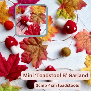 May include: A garland featuring felted red and white toadstools, orange felt balls, and artificial autumn leaves in shades of red, orange, and yellow. The toadstools measure 3cm x 4cm. The garland is strung on twine and includes a small inset image.
