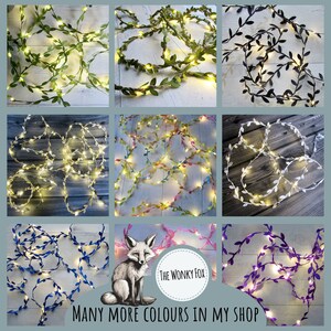 May include: A collage of images showing different colors of fairy lights with leaves. The lights are strung on a wire and have small, white bulbs. The leaves are made of fabric and are in various colors, including green, black, white, yellow, pink, blue, and purple. The text "The Wonky Fox" and "Many More Colours In My Shop" is visible in the image.