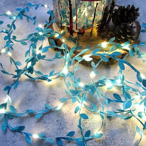 May include: A string of fairy lights with blue paper leaves, perfect for adding a touch of whimsy to any space.