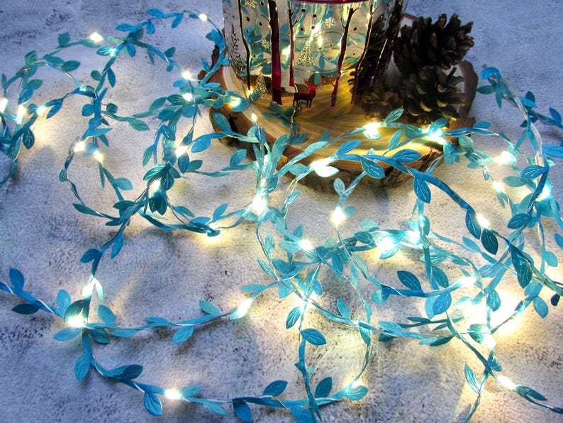 May include: A string of fairy lights with blue paper leaves, perfect for adding a touch of whimsy to any space.