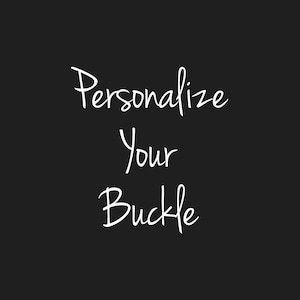 May include: White text on a black background that reads "Personalize Your Buckle".
