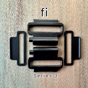 May include: Black metal watch band buckle with the text "fi" and "Series 3" printed on it. The buckle has two metal bars that slide into the buckle.