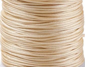May include: A spool of cream-colored waxed cord, perfect for jewelry making, macrame, or crafts.