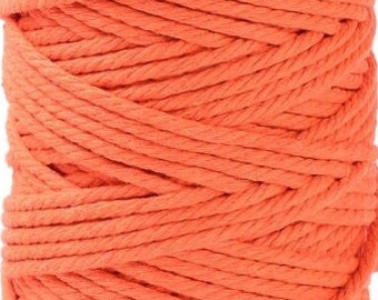 May include: A spool of bright orange cotton rope. The rope is tightly wound and has a smooth texture.
