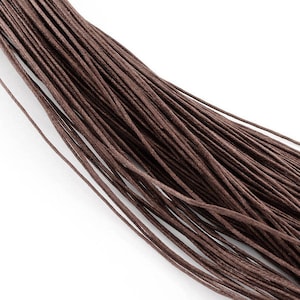 May include: A bundle of brown waxed cotton cord, a type of string used for jewelry making and crafts.