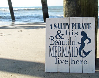 A salty pirate and his beautiful mermaid live here