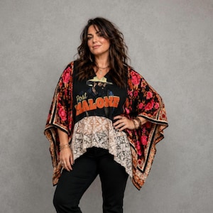 A black Post Maline graphic tee is framed with a vibrant scarf style print of dark pink roses and an ecru lace hem drapes from the tee. Both sides fall linger on each side with a flowy gauze. Oversized and a relaxed fit for dressy or casual pairing.