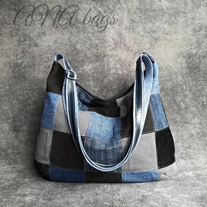 May include: A patchwork denim shoulder bag in shades of blue, grey, and black. The bag features a long, adjustable strap and the text "ONA bags" in cursive script.
