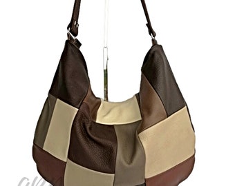May include: A brown leather patchwork hobo bag with a long strap. The bag is made of different shades of brown and beige leather.