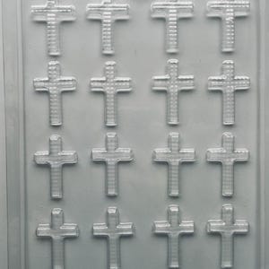 May include: A clear plastic mold with 15 cross-shaped cavities. The mold is designed for creating decorative items, possibly chocolates or candies. The text "LIFE OF THE PARTY P-70" is printed at the bottom.