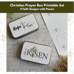 May include: Two rectangular metal boxes with white tops, inscribed with "Hope, Faith, Love" and "He is Risen" with a cross design. A sheet of paper with heart-shaped designs and lines is also visible.