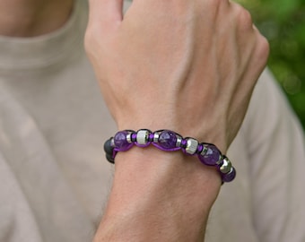 May include: A purple amethyst beaded bracelet with silver accents and black cord.