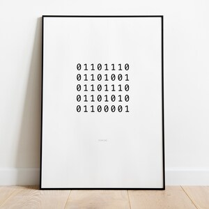 May include: A black framed print with a white background and a series of binary code numbers in black font. The numbers are arranged in a grid pattern. The text "Design" is printed in small font at the bottom of the print.
