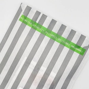 May include: A white paper bag with grey stripes and a green label with the text "01101110 01101111 01110011 01111001 00100001".