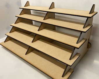 May include: A wooden tiered display stand with five shelves. The stand is made of natural wood and has a rustic look. It is perfect for displaying small items, such as jewelry, candles, or other crafts.