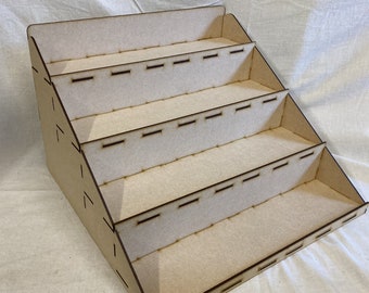 May include: A wooden display stand with five shelves. The shelves have slots cut into them, likely for holding small items.