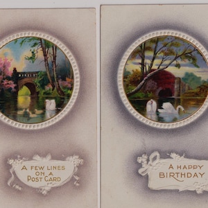May include: Three vintage postcards with circular landscape paintings. One shows a bridge, another swans, and the third a swan on a lake. Text includes "A few lines on a postcard", "A Happy Birthday", and "Sent in all sincerity".