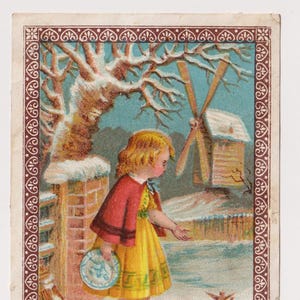Antica cartolina/ritaglio di Natale vittoriano: ragazza che dà da mangiare agli uccelli nella neve vicino al mulino a vento, effimera anni 1890
