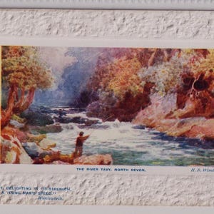 May include: Vintage postcard featuring a watercolor painting of the River Tavy in North Devon. The artwork depicts a man fishing in the river, surrounded by lush trees and rocky banks. The text reads "The River Tavy, North Devon."