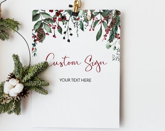 May include: A printable sign with a watercolor border of greenery, berries, and pine cones. The sign says "Custom Sign" in burgundy text and "Your Text Here" in black text.