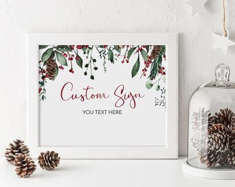 May include: A white framed printable sign with a watercolor design of green leaves, red berries, and pine cones. The text "Custom Sign" and "You Text Here" is in red.