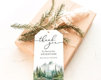 May include: A gift tag with the words "thank you" in elegant script. Below, it reads "For Sharing Our Adventure" and includes a name and date. The tag features a watercolor landscape of mountains and trees.