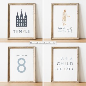 May include: A set of four framed prints in light wood frames. The first print shows a dark blue temple silhouette with the text I LOVE TO SEE THE TEMPLE. The second shows a figure in robes with the text WALK WITH ME. The third shows the number 8 and GREAT TO BE. The fourth shows the text I AM A CHILD OF GOD.