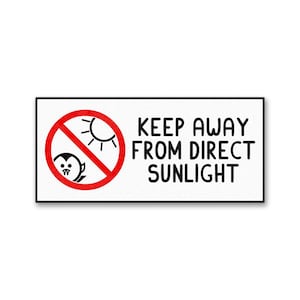 May include: A rectangular white sign with a black border featuring the text KEEP AWAY FROM DIRECT SUNLIGHT in black capital letters. To the left, a red circular prohibition symbol contains a black sun icon and a small vampire character.
