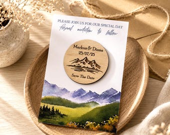 May include: A rectangular card featuring the text PLEASE JOIN US FOR OUR SPECIAL DAY and formal invitation to follow, with a circular wooden magnet displaying the names Markus & Diana, the date 25/07/25, and a mountain graphic above Save The Date.
