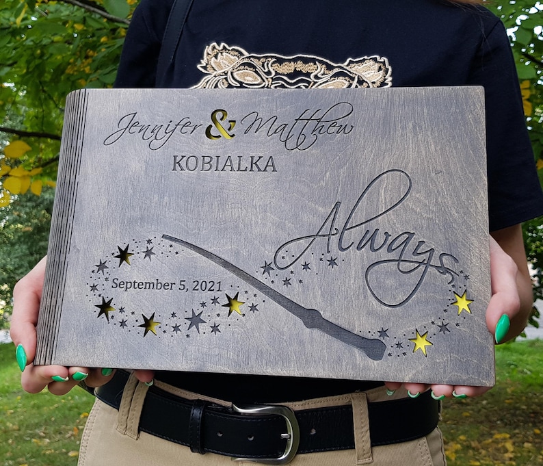 May include: A gray wooden wedding keepsake box with the names "Jennifer & Matthew" and the word "Always" engraved. The box features a wand design with star cutouts and the date "September 5, 2021".