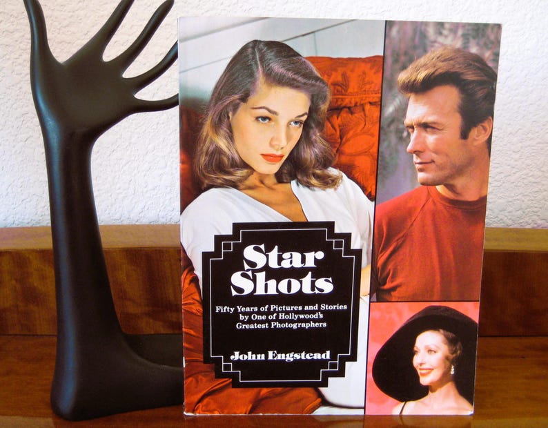 May include: A book titled "Star Shots" featuring images of Hollywood stars. The cover includes portraits of a woman in a white top, and a man in a red shirt. The book is by John Engstead.