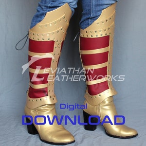 Puede incluir: Un par de botas altas hasta la rodilla de cuero dorado y rojo. Las botas tienen una parte superior de cuero dorado con paneles de cuero rojo y detalles dorados. Las botas tienen un tacón alto y una punta puntiaguda.