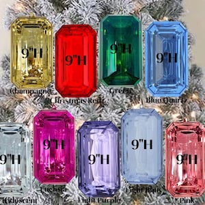 May include: Nine 9-inch tall emerald-cut Christmas ornaments in various colors, including champagne, red, green, blue, fuchsia, purple, light blue, and pink. Each ornament features the text "9"H" printed on the front.