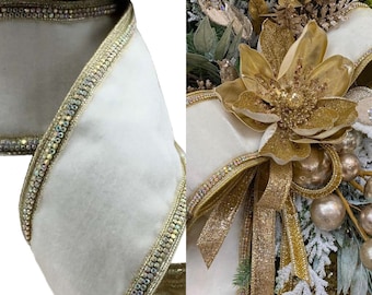 May include: White velvet ribbon with a gold and iridescent trim. The ribbon is decorated with a row of clear rhinestones.