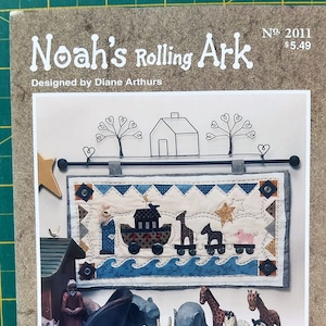May include: A craft pattern titled "Noah's Rolling Ark" by Diane Arthurs. The cover features a quilted banner with an ark, animals, and the text "Noah's Rolling Ark." Below are wooden animal figurines, including elephants, giraffes, and zebras. The pattern is from "The Powder Mill."