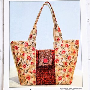 May include: A floral print Gracie handbag with a red button closure. The bag is 38 cm wide and 25 cm high. The text "Lazy Girl Designs" and "Gracie Handbag" are visible.