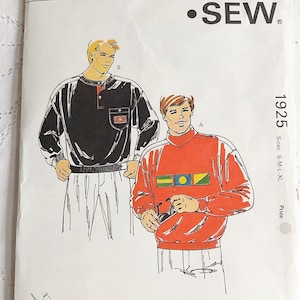May include: A sewing pattern for two men's sweaters. The pattern is called "Kwik Sew" and the pattern number is 1925. The sweaters are both long-sleeved and have a crew neck. One sweater is black with a pocket on the chest. The other sweater is red with a stripe of flags across the chest.