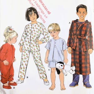 May include: Simplicity sewing pattern for children's pajamas and a robe. The pattern includes a red one-piece pajama, a blue and white striped pajama set, a floral pajama set, and a plaid robe. The pattern is for sizes 1/2, 1, and 2.