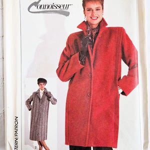 May include: A Simplicity sewing pattern envelope 7748 for a coat. The front shows a red coat and a grey herringbone coat. Text includes Simplicity, 7748, 14, Eur 42, and Connoisseur Collection. The envelope is white with black text.