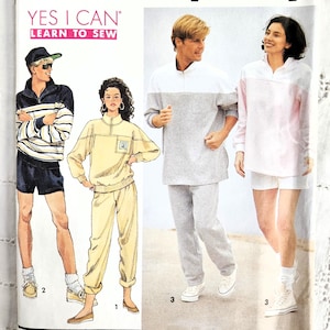 May include: A vintage Simplicity sewing pattern featuring illustrations of athletic wear. The pattern includes images of a tracksuit, shorts, and a long-sleeved top. The text "YES I CAN LEARN TO SEW" is displayed on the front.