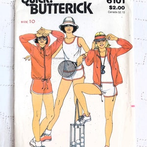 May include: Vintage Butterick sewing pattern with illustrations of tennis outfits. The cover depicts three figures in orange tracksuits, white shorts, and tennis visors. The text reads "Winning Tennis Gear from Chrissie Evert."