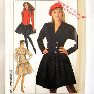 May include: Simplicity sewing pattern, size 8, featuring illustrations of a jacket and skirt ensemble. The pattern includes a woman wearing a navy blue jacket with gold buttons and a black skirt. The package has the number 8800.