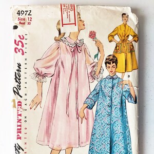 May include: Vintage Simplicity sewing pattern number 4972 for a women's robe. The pattern includes three different styles: a pink robe with a lace trim, a blue robe with a floral print, and a yellow robe with a pocket detail. The pattern is printed on a white background and includes instructions for sewing the robes.