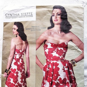 May include: A vintage sewing pattern for a strapless dress with a floral print. The pattern is by Cynthia Steffe, an American designer, and is for sizes 4-6-8-10. The pattern number is V1174.